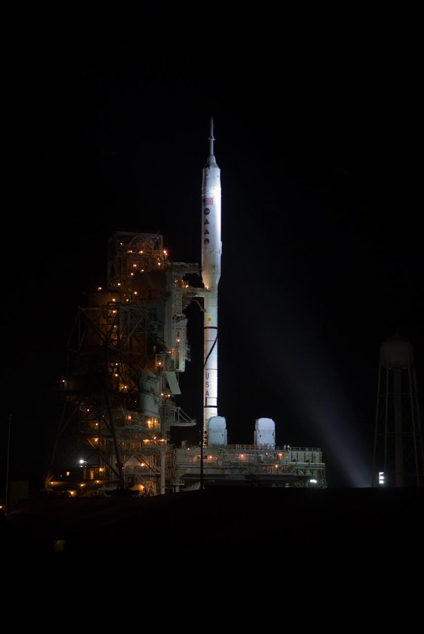 Commercial orbital rocket liftoff at dusk with flame plume illuminating the launchpad