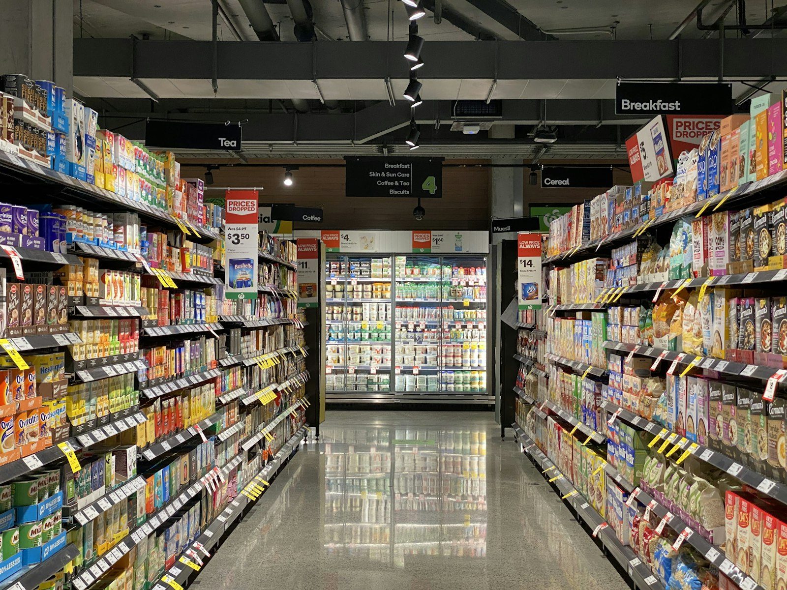 Commercial refrigerated display cabinets in a grocery supermarket aisle.