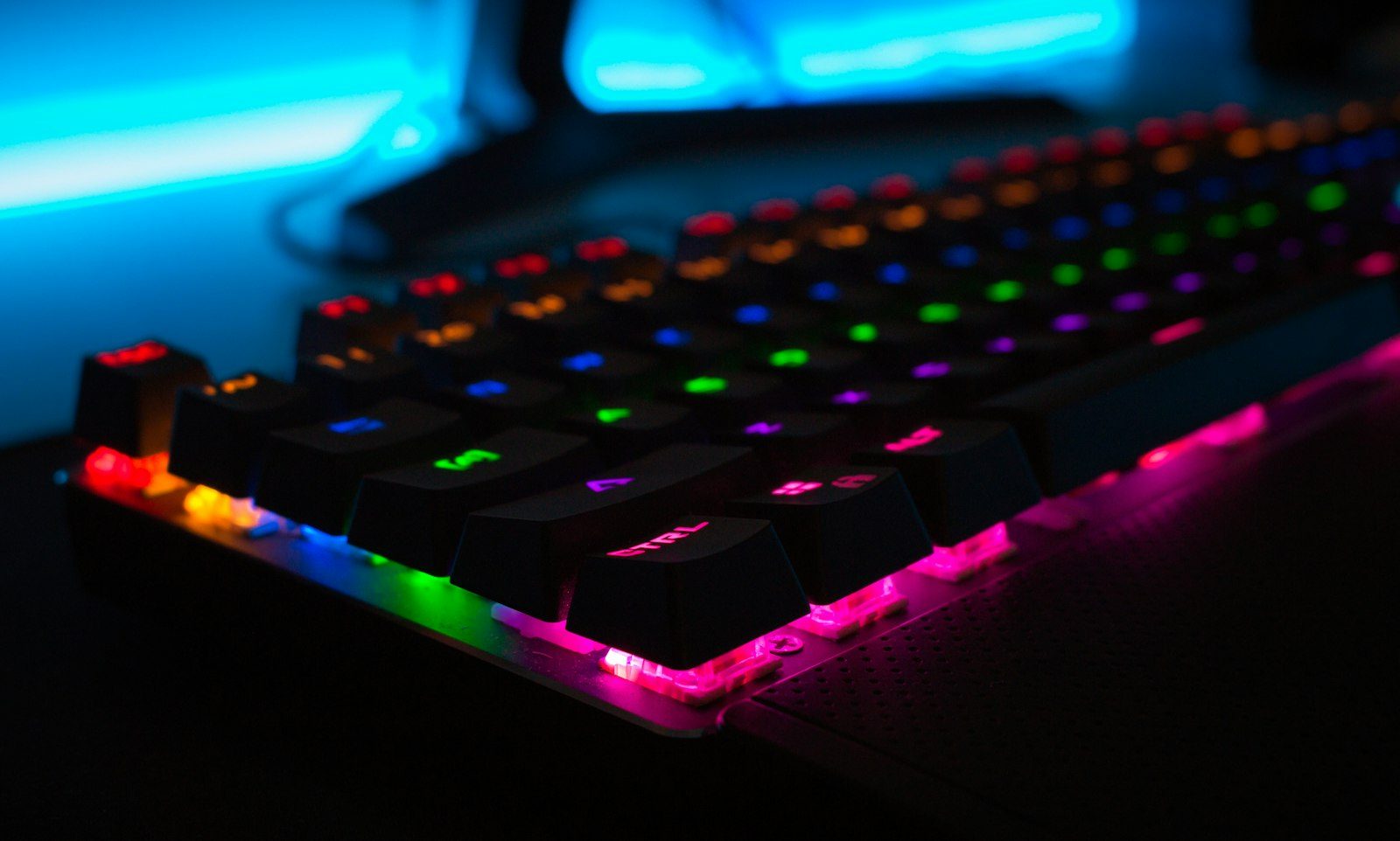 Mechanical keyboard and gaming interface monitor showcasing complex real-time simulation controls