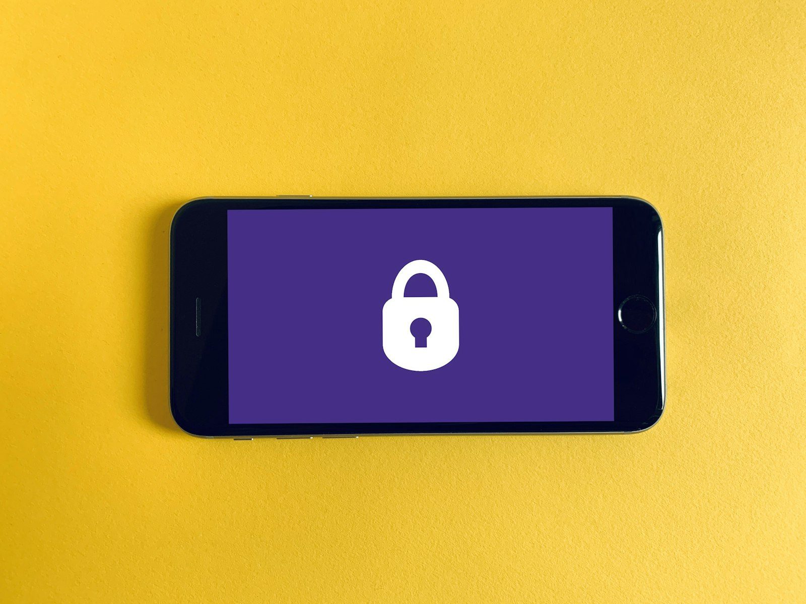 A solid metal security padlock and illuminated electronic data vault depicting cryptographic key protection mechanisms.